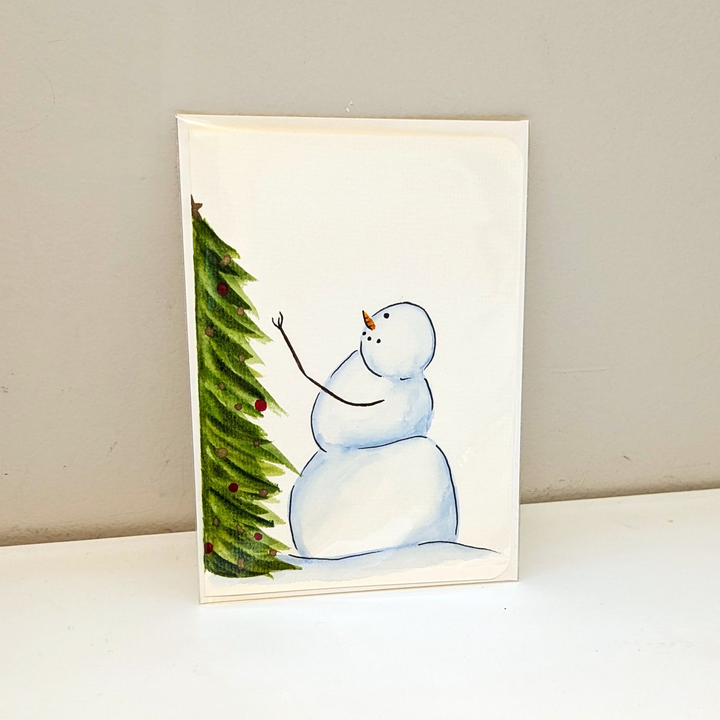 Christmas Card - Snowman decorating a Christmas tree, hand painted watercolor, blank inside